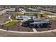 Aerial view of the community clubhouse with a pool and playground surrounded by new construction homes at 3390 E Audrey Dr, San Tan Valley, AZ 85143