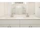 Bathroom vanity with double sinks and a large mirror reflecting the shower stall at 3390 E Audrey Dr, San Tan Valley, AZ 85143