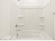 Spotless bathroom with a shower featuring built-in shelving for storage at 3390 E Audrey Dr, San Tan Valley, AZ 85143