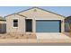 Inviting single-story home with a blue garage door and tidy front yard at 3390 E Audrey Dr, San Tan Valley, AZ 85143
