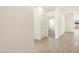 Bright hallway with tile flooring leads to carpeted rooms and features neutral colors at 3390 E Audrey Dr, San Tan Valley, AZ 85143