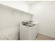 Clean laundry room featuring a new washer and dryer and a shelf for storage at 3390 E Audrey Dr, San Tan Valley, AZ 85143