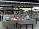 Community pool area featuring a fire pit with seating, umbrellas, and lounge chairs for a relaxing and social atmosphere at 3390 E Audrey Dr, San Tan Valley, AZ 85143