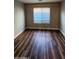 Bedroom with wood-look floors and window with blinds at 36224 W Picasso St, Maricopa, AZ 85138