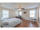 Bright bedroom with wood floors, ceiling fan, and window coverings at 36224 W Picasso St, Maricopa, AZ 85138