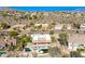 Aerial view showcases a backyard pool in desert community with mountain views and bright blue sky at 15155 E Westridge Dr, Fountain Hills, AZ 85268