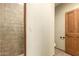 Bathroom with tiled shower, wood door, toilet and neutral colored walls and floors at 15155 E Westridge Dr, Fountain Hills, AZ 85268