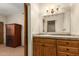 Bathroom featuring a tile countertop, wood cabinets and traditional lighting fixture at 15155 E Westridge Dr, Fountain Hills, AZ 85268