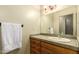 Bathroom featuring a tile countertop, wood cabinets and traditional lighting fixture at 15155 E Westridge Dr, Fountain Hills, AZ 85268
