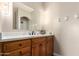 Bathroom featuring a wooden vanity with a marble countertop and a large mirror at 15155 E Westridge Dr, Fountain Hills, AZ 85268
