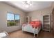 Bright bedroom with a ceiling fan, carpet floors, and a view to the outdoors at 15155 E Westridge Dr, Fountain Hills, AZ 85268