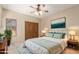 Cozy bedroom with a ceiling fan, wood closet doors, neutral colors, and bedside lamps at 15155 E Westridge Dr, Fountain Hills, AZ 85268