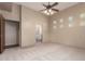 Bright bedroom with a ceiling fan, carpet floors, and view to a bathroom at 15155 E Westridge Dr, Fountain Hills, AZ 85268