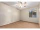 This bedroom is spacious and has a ceiling fan with a light fixture and a window at 15155 E Westridge Dr, Fountain Hills, AZ 85268