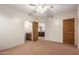 This bedroom features access to the bathroom and living area with a ceiling fan at 15155 E Westridge Dr, Fountain Hills, AZ 85268