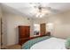 Cozy bedroom featuring a ceiling fan, wood furniture, and an attached bathroom at 15155 E Westridge Dr, Fountain Hills, AZ 85268