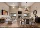 Bright living room featuring high ceilings, fireplace, dining area, and sliding glass doors to outdoor living at 15155 E Westridge Dr, Fountain Hills, AZ 85268