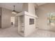 Cozy living room with a fireplace, built-in shelves, and a view to the outdoors at 15155 E Westridge Dr, Fountain Hills, AZ 85268