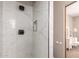 Walk-in shower featuring white marble tiles, bronze shower hardware and a built-in shelf at 15155 E Westridge Dr, Fountain Hills, AZ 85268