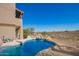 Backyard swimming pool with rock waterfall feature, landscaped border, and desert views at 15155 E Westridge Dr, Fountain Hills, AZ 85268