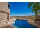 Swimming pool with rock features and desert landscaping in backyard at 15155 E Westridge Dr, Fountain Hills, AZ 85268