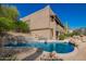 Swimming pool with waterfall, desert landscaping, and rock border at 15155 E Westridge Dr, Fountain Hills, AZ 85268