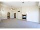 Open living room with neutral carpet and a fireplace, offering a cozy and inviting atmosphere at 16068 W Edgemont Ave, Goodyear, AZ 85395