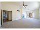 Spacious living room featuring a fireplace, ceiling fan, and sliding door to enjoy natural light at 16068 W Edgemont Ave, Goodyear, AZ 85395