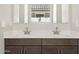 Bathroom boasting a double sink vanity with modern fixtures and white countertops at 17666 W Pierson St, Goodyear, AZ 85395