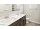 Bathroom with dual sinks, wood floors, and white cabinets at 17666 W Pierson St, Goodyear, AZ 85395