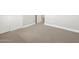 The bedroom featuring carpet, baseboards, and a doorway at 17666 W Pierson St, Goodyear, AZ 85395