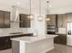 Modern kitchen with stainless steel appliances, white countertops, and dark cabinetry at 17666 W Pierson St, Goodyear, AZ 85395