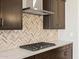 Close up of kitchen with modern appliances, designer backsplash, and white countertops at 17666 W Pierson St, Goodyear, AZ 85395