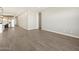 An airy living space featuring modern wood-look tile flooring and access to additional rooms at 17666 W Pierson St, Goodyear, AZ 85395