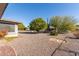 Landscaped backyard with gravel and mature trees at 18609 N Kiva Dr, Sun City, AZ 85373