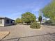 Landscaped backyard with gravel and mature citrus trees at 18609 N Kiva Dr, Sun City, AZ 85373