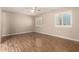 Well-lit bedroom with wood-look floors and window shutters at 18609 N Kiva Dr, Sun City, AZ 85373