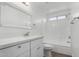 Updated bathroom with white vanity, quartz countertop, and bathtub at 22538 W Mohave St, Buckeye, AZ 85326