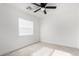 Simple bedroom with ceiling fan and window at 22538 W Mohave St, Buckeye, AZ 85326