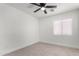 Bright bedroom with ceiling fan and window at 22538 W Mohave St, Buckeye, AZ 85326