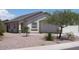 One-story house with light-colored exterior, landscaping, and a gravel driveway at 22538 W Mohave St, Buckeye, AZ 85326