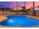 Stunning kidney-shaped pool with patio and lounge chairs; sunset view at 2257 W Periwinkle Way, Chandler, AZ 85248