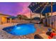 Serene kidney-shaped pool with patio and lounge chairs; sunset view at 2257 W Periwinkle Way, Chandler, AZ 85248