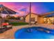 Peaceful kidney-shaped pool with patio and lounge chair; sunset view at 2257 W Periwinkle Way, Chandler, AZ 85248