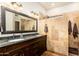 Elegant bathroom with double vanity, large mirror, and walk-in shower at 2257 W Periwinkle Way, Chandler, AZ 85248