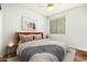 Cozy bedroom featuring a queen bed, window, and wood floors at 2257 W Periwinkle Way, Chandler, AZ 85248