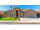 Beautiful tan house with a large grassy front yard and two-car garage at 2257 W Periwinkle Way, Chandler, AZ 85248