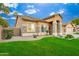 Single story house with stone accents and a lush lawn at 2257 W Periwinkle Way, Chandler, AZ 85248