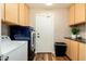 Laundry room with washer, dryer, cabinets, and countertop at 2257 W Periwinkle Way, Chandler, AZ 85248