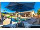 Relaxing pool area with lounge chairs and patio umbrellas at 2257 W Periwinkle Way, Chandler, AZ 85248